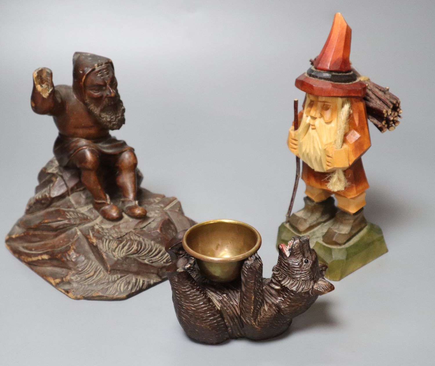 Two Black Forest type carvings, c.1900 and a similar modern carving, tallest 18cm